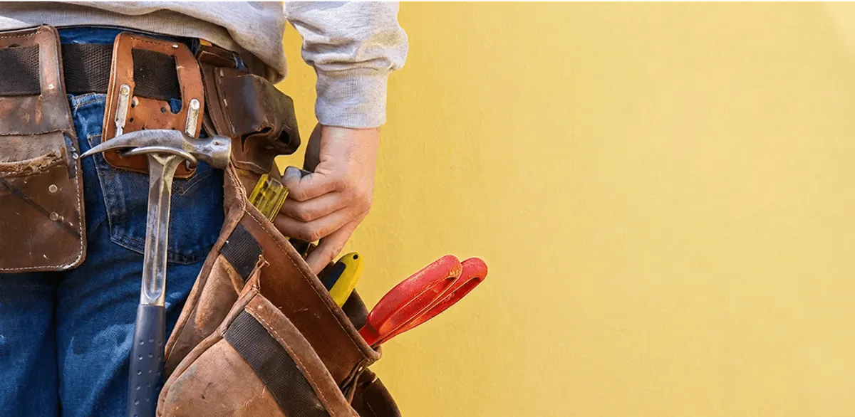 Handyman with tool belt ready for home repairs and maintenance in Tallahassee, FL
